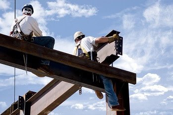 Iron workers building a new building at a construction site.